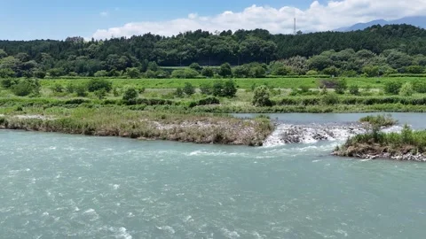 Clear river flows through lush green countryside Stock Footage 339129163