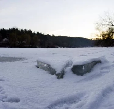 Clear river ice in cold winter morning under sunbeams Stock Photos