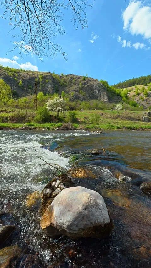 Clear river rushes over smooth stones. Bigar Waterfall, Serbia. Vertical Видео 333700689