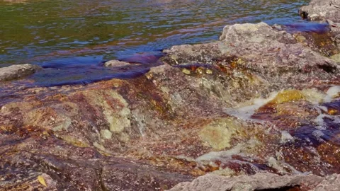 Clear River Water Flow Over Textured Rocks On A Sunny Day, Natural Scene Stockbeeldmateriaal 332725709