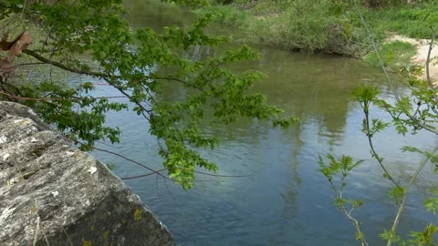 Clear River Water Flowing Beneath Historic Stone Bridge in Natural Landscape Видео 330338226