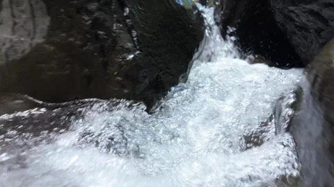 Clear river water flowing over rocks in slow motion Stock Footage 302939089