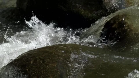 The clear river water flows over the rocks  Stock Footage 287295748