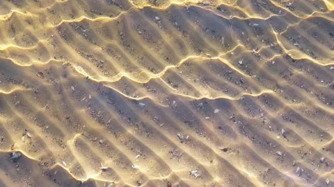Clear river water with small waves, through which you can see sandy bottom .. Stock Footage 297365662