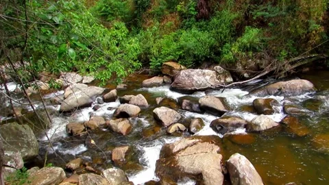 Clear river waters flow from the mountains to form small waterfalls between.. Stock Footage 280321740