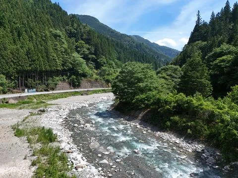 Clear river winds through rocky bed Stock Photos