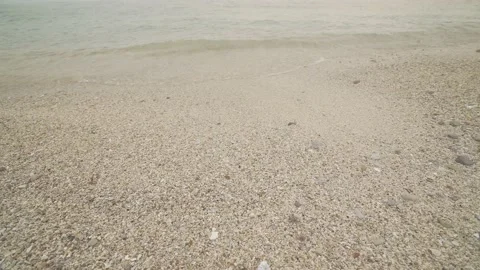 Clear sea, Calm waves surf on the tiny pebbles beach. Stock Footage 235583561