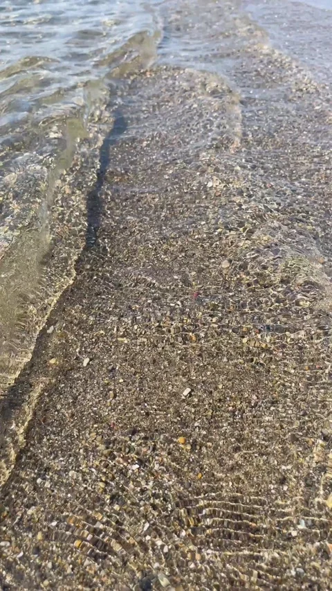 Clear sea water gently lapping over shallow sandy beach Stock Footage 328716117