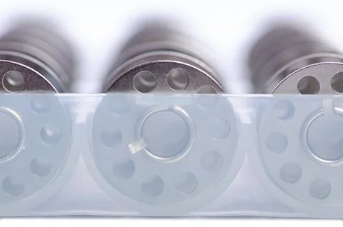 Clear sewing machine bobbins spools Stock Photos