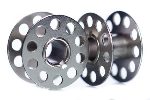 Clear sewing machine bobbins spools Stock Photos
