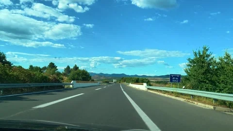 Clear sky above highway with clouds and distant mountains. Macedonia Stock Footage 340638407