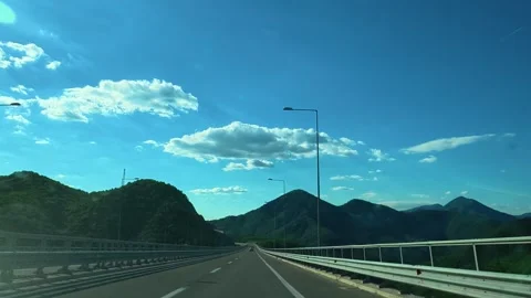 Clear sky above winding highway through green hills. Macedonia Stock Footage 340638601