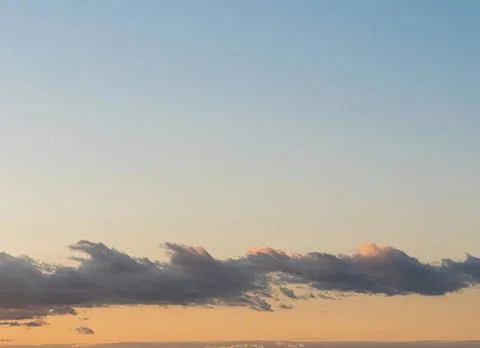 Clear sky with a few clouds during sunset or sunrise Stock Photos
