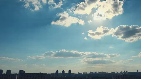 Clear sky with fluffy clouds timelapse. Time lapse footage of clouds with rays Stock Footage 251730998