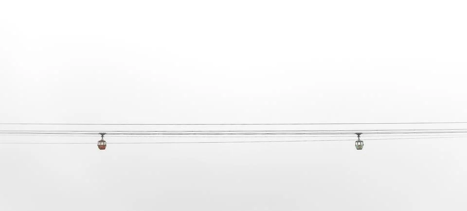 Clear sky overhead with minimal cloud coverage and electrical wires against.. Stock Photos