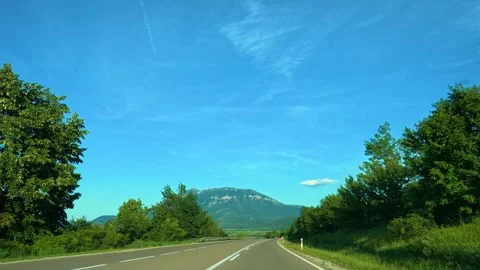 Clear sky, road ahead, distant mountain, green trees. Mount Rtanj Area, Serbia Stock Footage 340897735