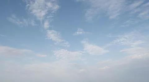 Clear sky with scattered white clouds. The clouds vary in size and shape, cre Foto stock