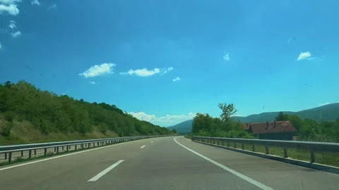 Clear sky stretches above winding highway. Balkans, Serbia Vídeo Stock 337486643