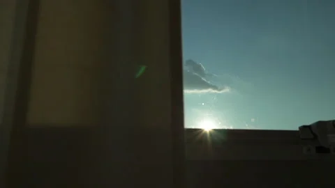 Clear sky view from open window with brown curtain, inside looking out slow.. Stock Footage 249642600