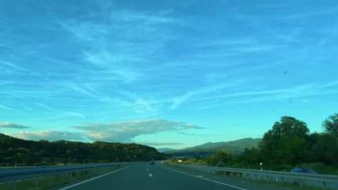 Clear sky with wispy clouds stretches above highway. Serbia Stock Footage 340638878