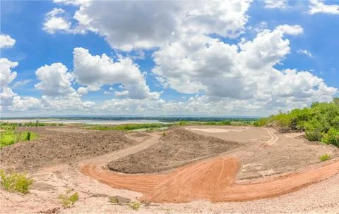 Clear soil at site construction under blue sky and nice cloud midday. Stock Photos