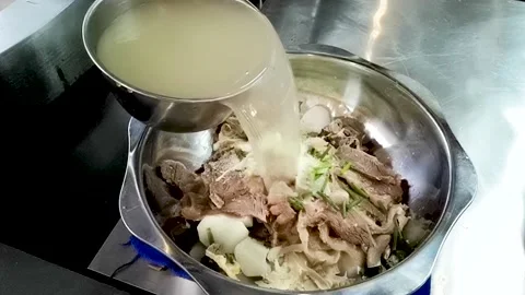 Clear soup beef hot pot to add soup upgrade slow action Stock Footage 161871501