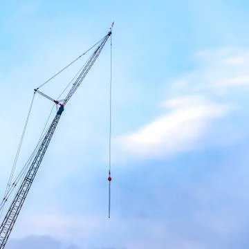 Clear Square A lifting crane viewed against a beautiful blue sky filled with Stock Photos