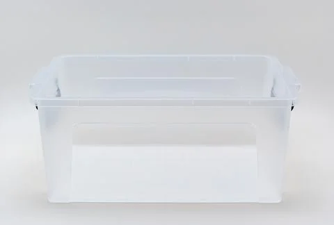 Clear storage bin on plain background for organization and display 库存照片