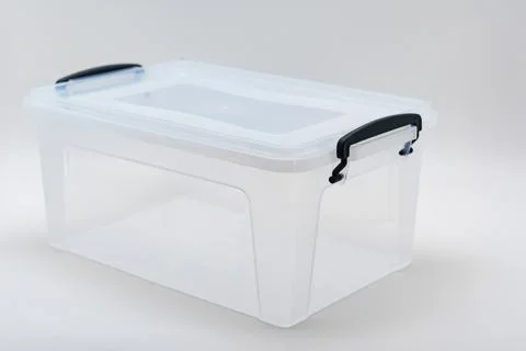 Clear storage container with lid placed on a neutral background 库存照片