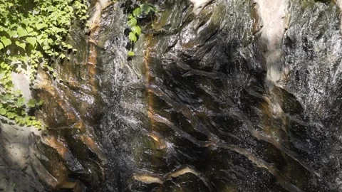 A clear stream flowing through stone boulders. Stock Footage 237957633