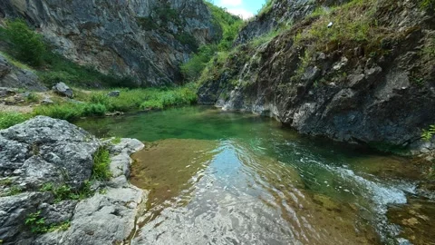 Clear stream flows through rocky canyon walls. Gradasnica River Canyon, Serbia Stock Footage 342320214