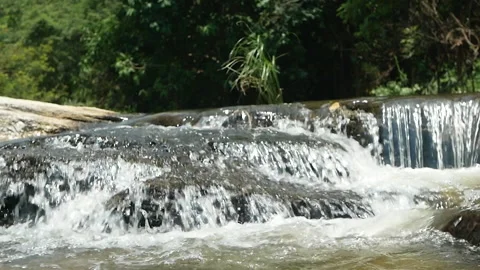 Clear stream running fast on stones covered with moss in national park.Waterfall Video stock 138907131