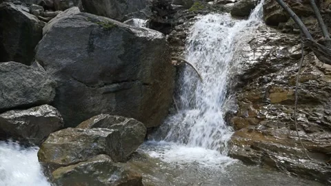 Clear stream running through stone boulders in carpathians. Abundant river Video stock 236569980
