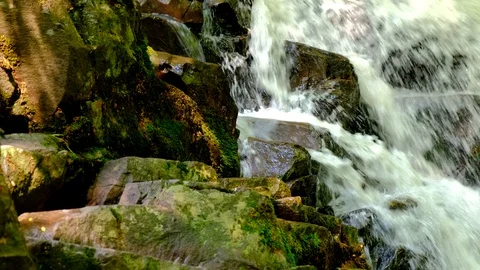 Clear stream water flow between dark stones. Stock Footage 124231039