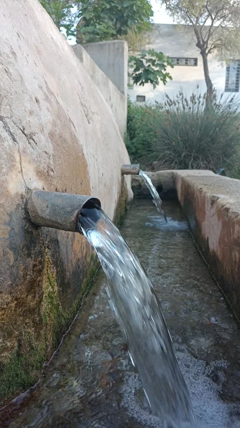 Clear Stream Water Flowing From Ancient Stone Fountain Pipes Video stock 335081775