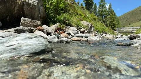 Clear Stream Water Gently Flowing in Slow Motion Through Rocky Terrain in t.. Stock Footage 339606984