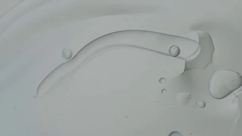 Clear substance with bubbles rotates back and forth Stock Footage 77779183