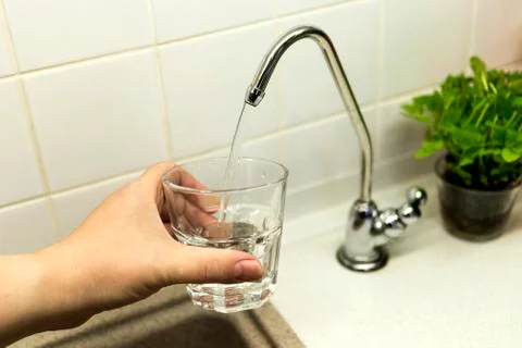 Clear transparent cold water flows from the tap Stock Photos