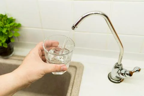 Clear transparent cold water flows from the tap Stock Photos