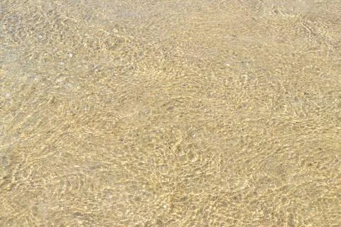 Clear turquoise blue waves wave water and beach sand Thailand. Stock Photos