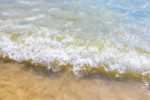 Clear turquoise blue waves wave water and beach sand Thailand. Stock Photos