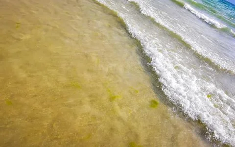 Clear turquoise blue waves wave water and beach sand Thailand. Stock Photos
