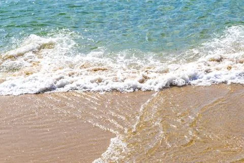 Clear turquoise blue waves wave water and beach sand Thailand. Stock Photos