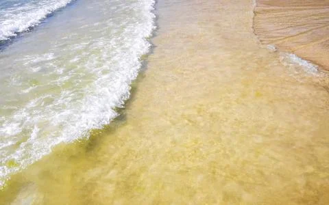 Clear turquoise blue waves wave water and beach sand Thailand. Stock Photos