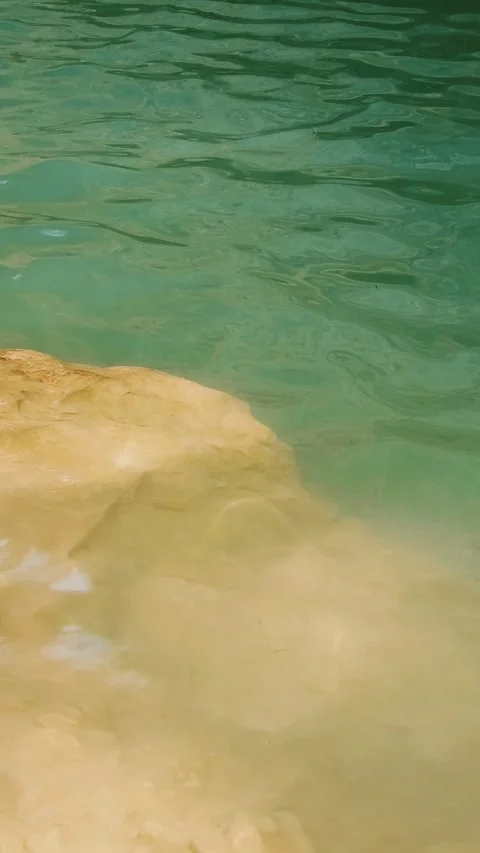 Clear Turquoise River Water Flowing Over Sand And Rock - 4k Vertical Footage Video stock 337934460