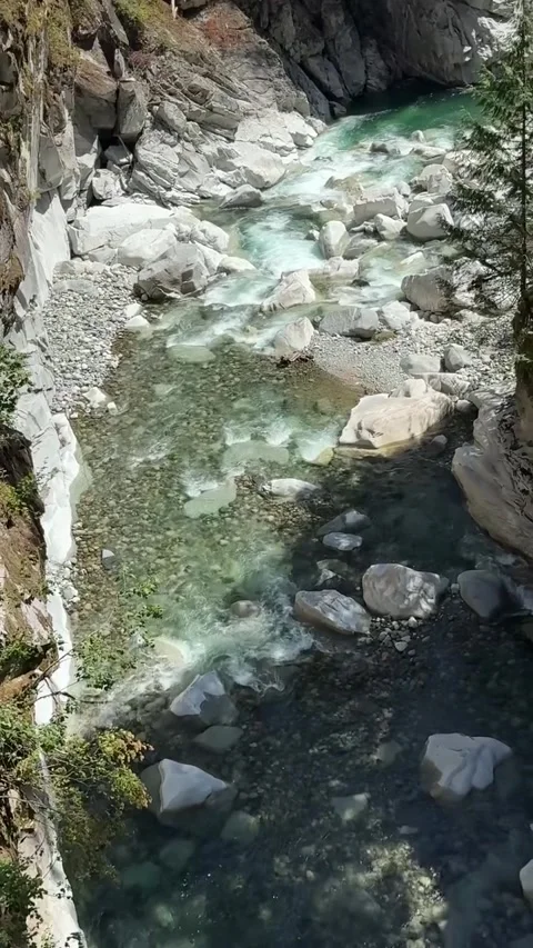 Clear Turquoise Stream Flowing Through Rocky Canyon Stock Footage 342266541