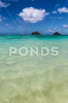 Clear turquoise water and two islands view at Lanikai beach, Oahu, Hawaii Stock Photos