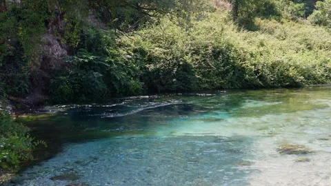 Clear turquoise water flowing through the Syri i Kalter Blue Eye spring in 스톡 동영상 333794925