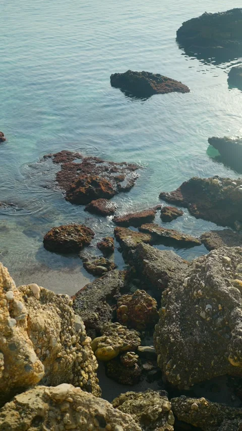 Clear turquoise water gently lapping on the rocky coast of Nerja, Spain Video stock 343389853