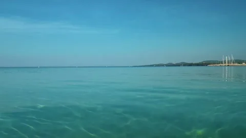 Clear turquoise water gently ripples toward the shore. Nikiti, Greece Vídeos de archivo 338347357